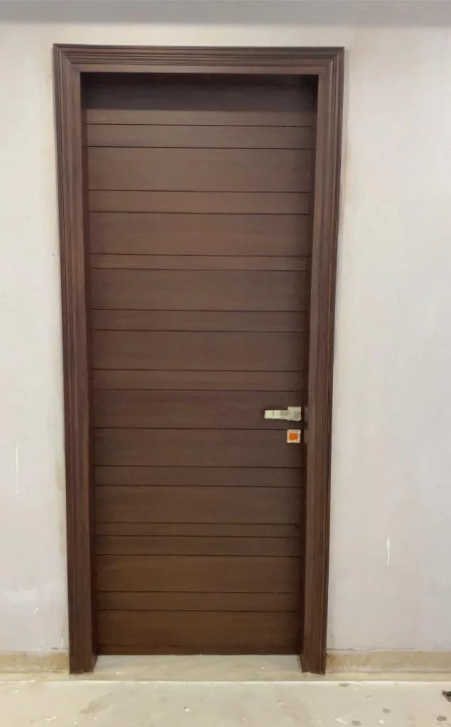 Brown wood interior door with horizontal paneling and simple hardware.