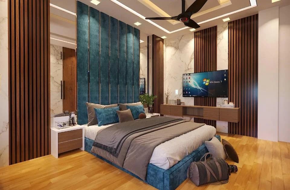 Modern bedroom with blue upholstered bed and wood panel accents.