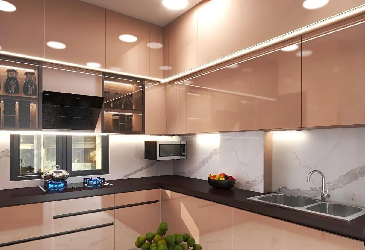 Modern rose gold kitchen with dark countertops and marble backsplash.