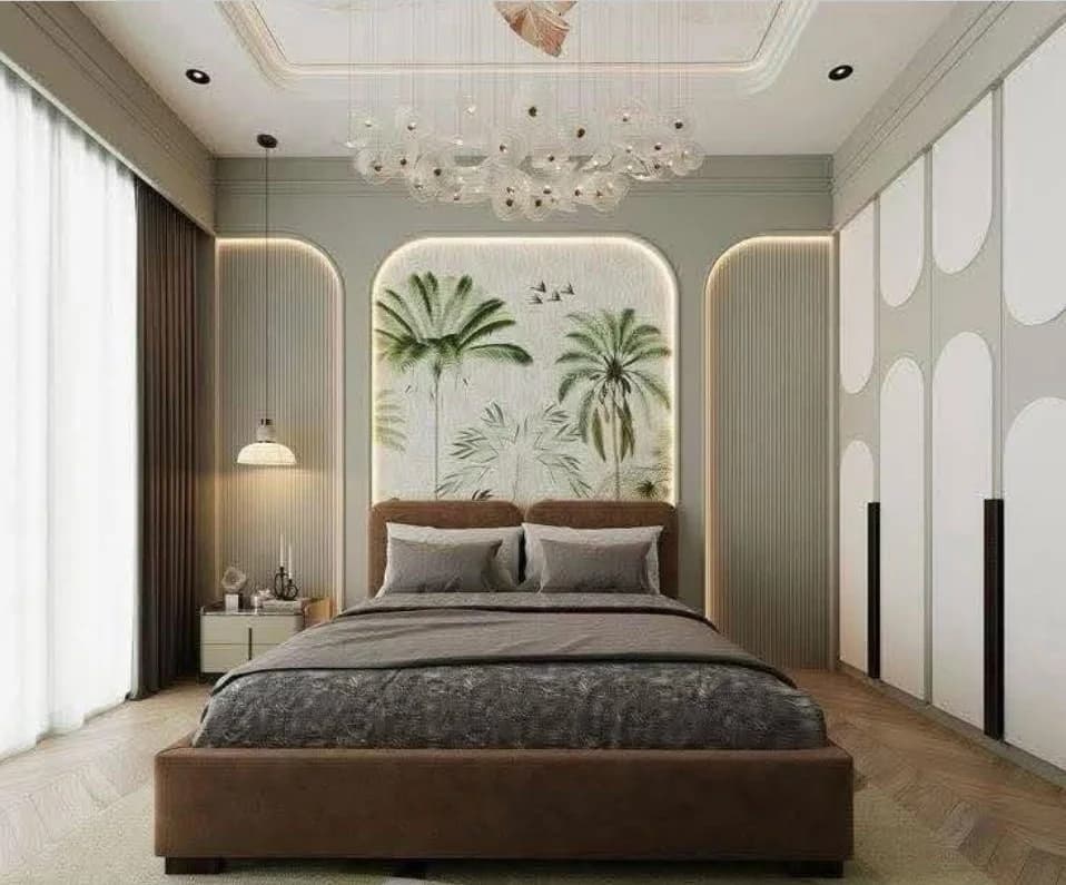 Modern tropical bedroom with palm tree wallpaper, brown bed, and cloud chandelier.